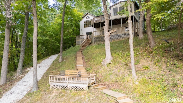 rear view of property featuring a wooden deck