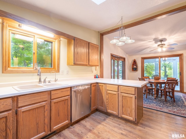 kitchen with hanging light fixtures, kitchen peninsula, dishwasher, light hardwood / wood-style flooring, and sink