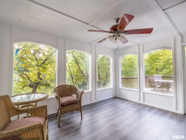 sunroom / solarium with ceiling fan and vaulted ceiling