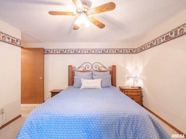 carpeted bedroom with a textured ceiling and ceiling fan