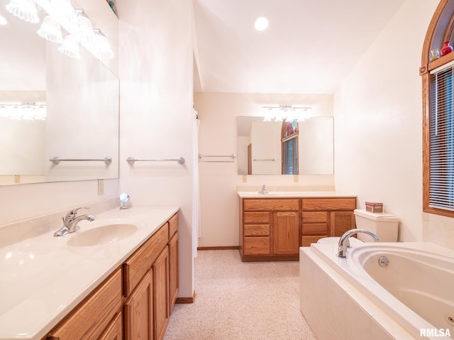 bathroom featuring vanity and a relaxing tiled tub