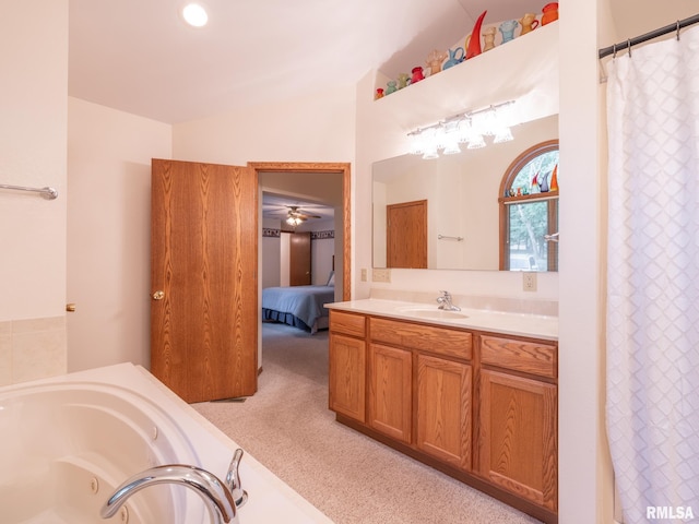 bathroom featuring lofted ceiling, ceiling fan, vanity, and a bathing tub