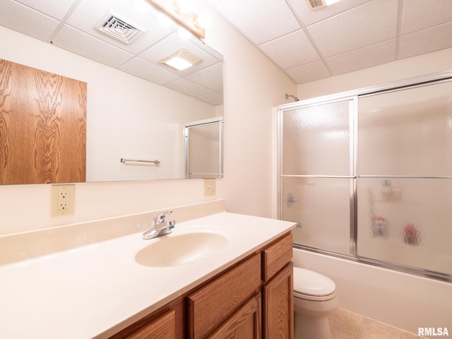 full bathroom with vanity, a paneled ceiling, toilet, and tile patterned floors