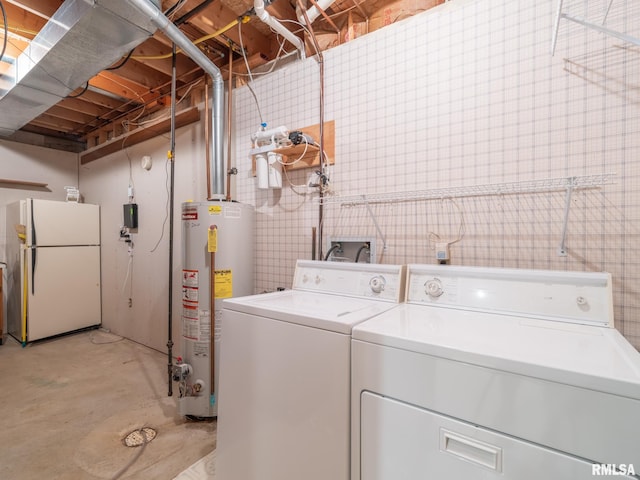 laundry room with gas water heater and washing machine and clothes dryer