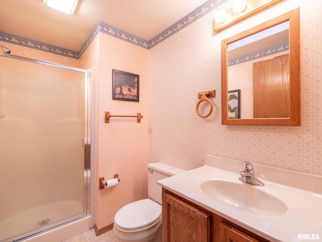 bathroom with tile patterned flooring, a shower with door, toilet, and vanity