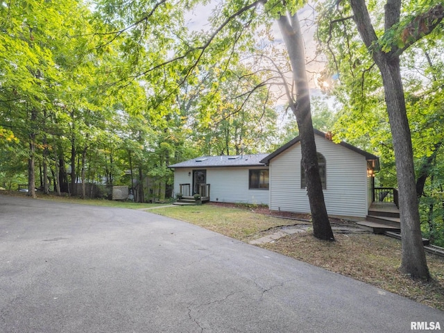 view of front of home featuring a front yard and a deck