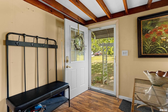 interior space with beam ceiling and hardwood / wood-style floors