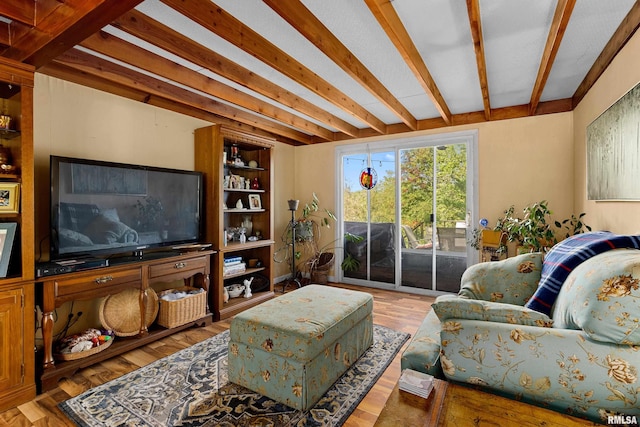 living room featuring beam ceiling and hardwood / wood-style flooring