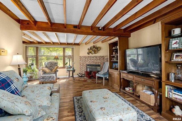 913 E Truitt Ave, Chillicothe, IL 61523 - living area featuring beamed ceiling, wood finished floors, and a brick fireplace