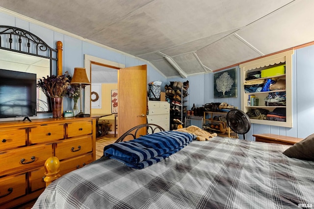 bedroom featuring hardwood / wood-style flooring and lofted ceiling