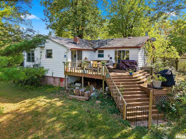 913 E Truitt Ave, Chillicothe, IL 61523 - rear view of property featuring a wooden deck, a yard, stairs, a chimney, and fence