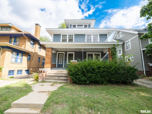 view of front of house with a front yard and covered porch