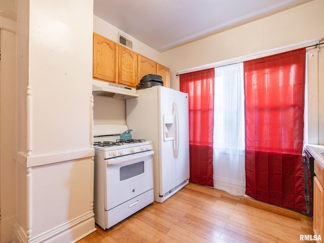 kitchen featuring light wood-type flooring and white appliances