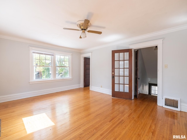 spare room with ornamental molding, ceiling fan, and light hardwood / wood-style flooring