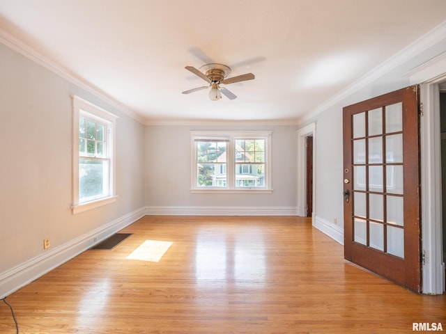 empty room featuring light wood-type flooring, ornamental molding, ceiling fan, and plenty of natural light