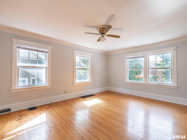 spare room with ornamental molding, light wood-type flooring, and ceiling fan