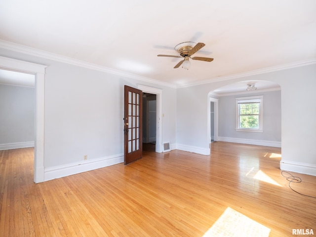 spare room featuring ceiling fan, light wood-type flooring, and crown molding