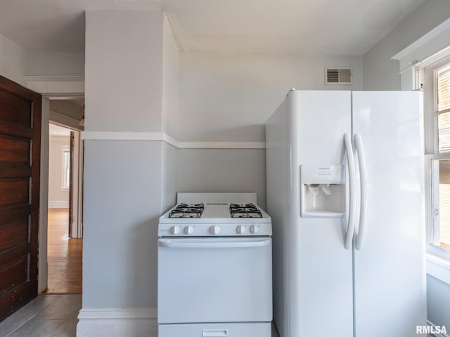 kitchen featuring light hardwood / wood-style floors and white appliances