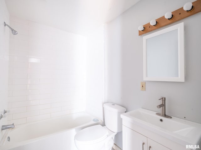 full bathroom with tiled shower / bath, vanity, and toilet