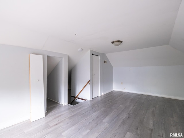 bonus room featuring light hardwood / wood-style floors and lofted ceiling