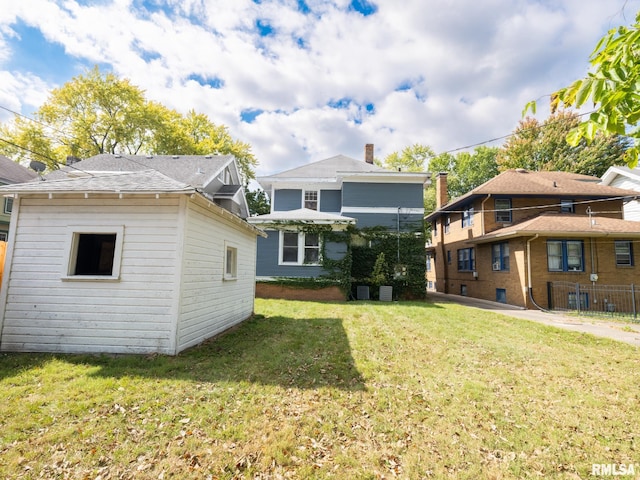 rear view of house with a lawn