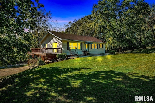 view of front of home featuring a lawn and a deck