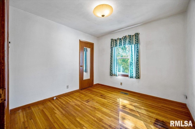 spare room with light hardwood / wood-style flooring