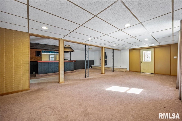 basement featuring a drop ceiling and carpet