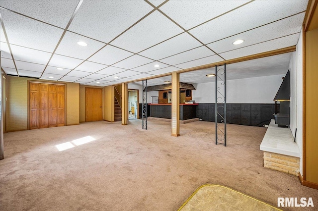 basement featuring carpet and a paneled ceiling