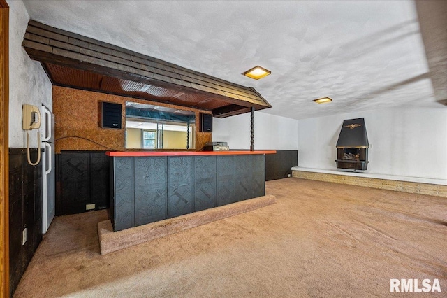 bar with a textured ceiling and carpet floors