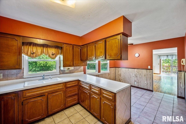 kitchen featuring sink, kitchen peninsula, and a wealth of natural light