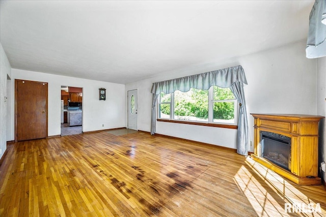 unfurnished living room with hardwood / wood-style floors