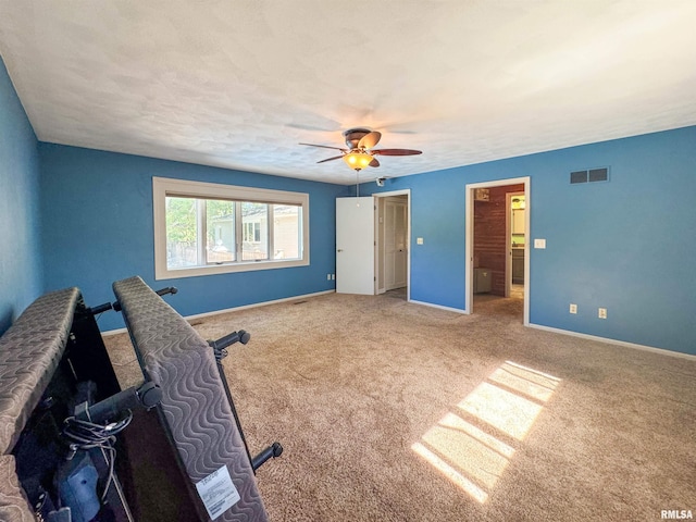 interior space with ceiling fan and carpet floors