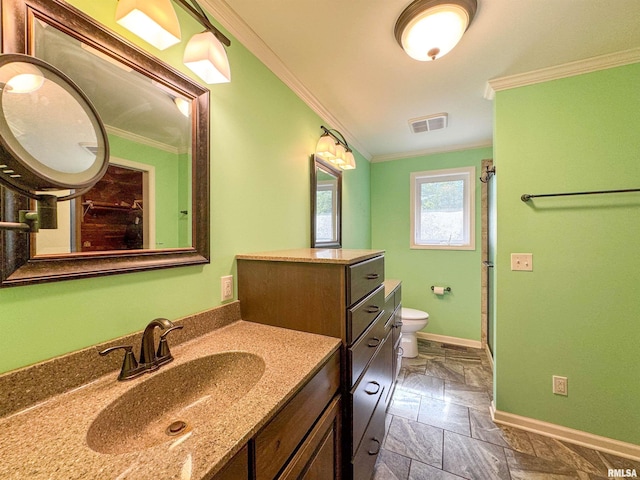 bathroom with crown molding, vanity, and toilet