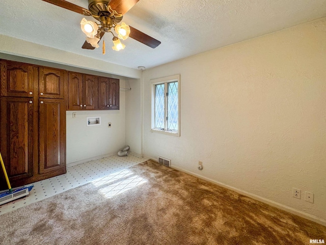 interior space with cabinets, electric dryer hookup, light carpet, ceiling fan, and hookup for a washing machine