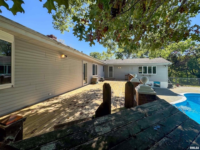 back of house featuring a swimming pool side deck