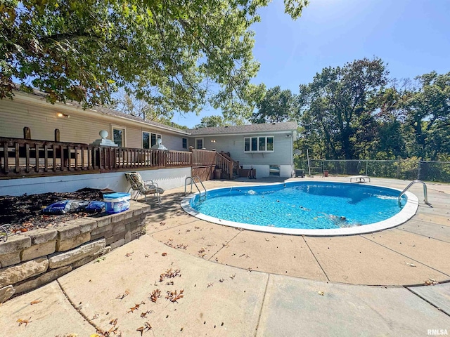 view of swimming pool with a deck and a patio