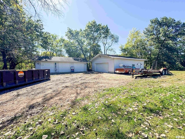 exterior space featuring an outbuilding, a garage, and a wooden deck