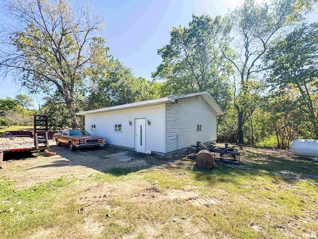 view of outbuilding with a lawn