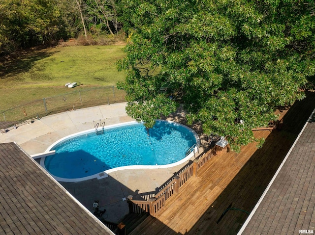 view of pool with a lawn, a diving board, a deck, and a patio area