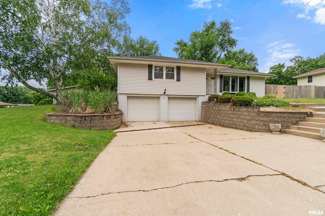 view of front of property featuring a garage and a front lawn