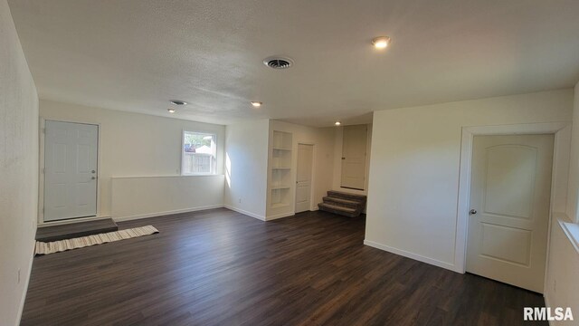 unfurnished living room with dark hardwood / wood-style floors