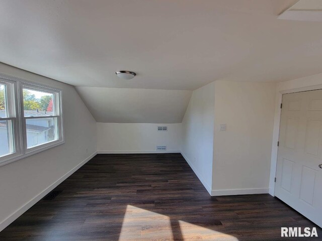 bathroom with an enclosed shower and hardwood / wood-style floors