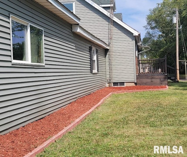 view of property exterior featuring a yard and a deck