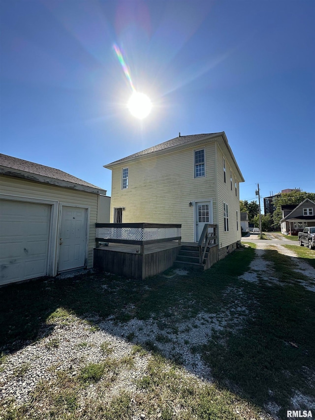 rear view of property with a garage