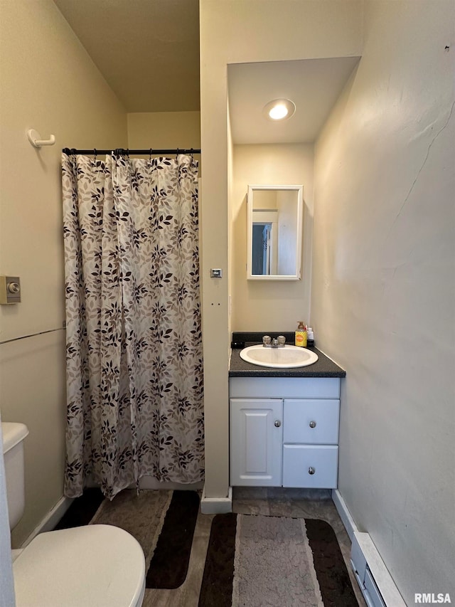 bathroom featuring hardwood / wood-style flooring, a shower with shower curtain, baseboard heating, vanity, and toilet