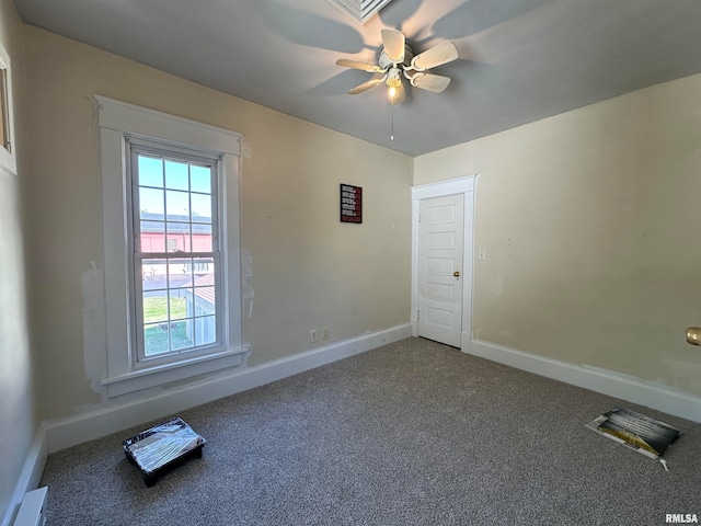 carpeted spare room with ceiling fan