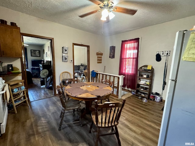 dining area featuring a textured ceiling, dark hardwood / wood-style flooring, and ceiling fan