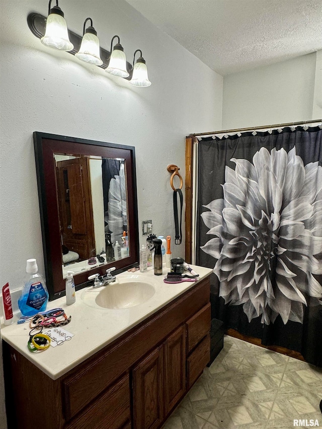 bathroom with a textured ceiling and vanity