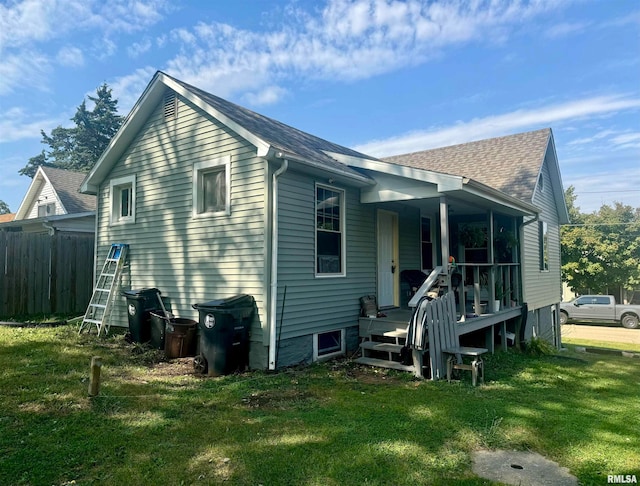 rear view of property with a lawn